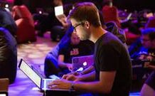 Image of a person using a laptop in the clouds representing cloud computing