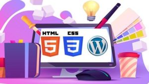 Person learning web design with HTML, CSS, and WordPress using a computer and a notepad