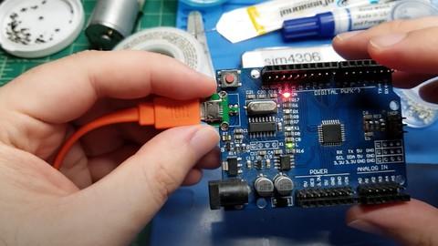 Image of a person working with Arduino board