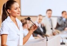 Image of a woman confidently speaking to an audience