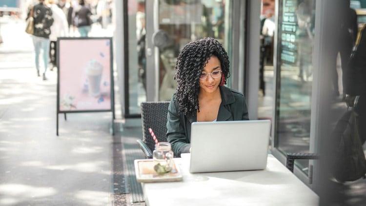 A person working on a laptop with ChatGPT on the screen, illustrating how to earn money online using AI methods.